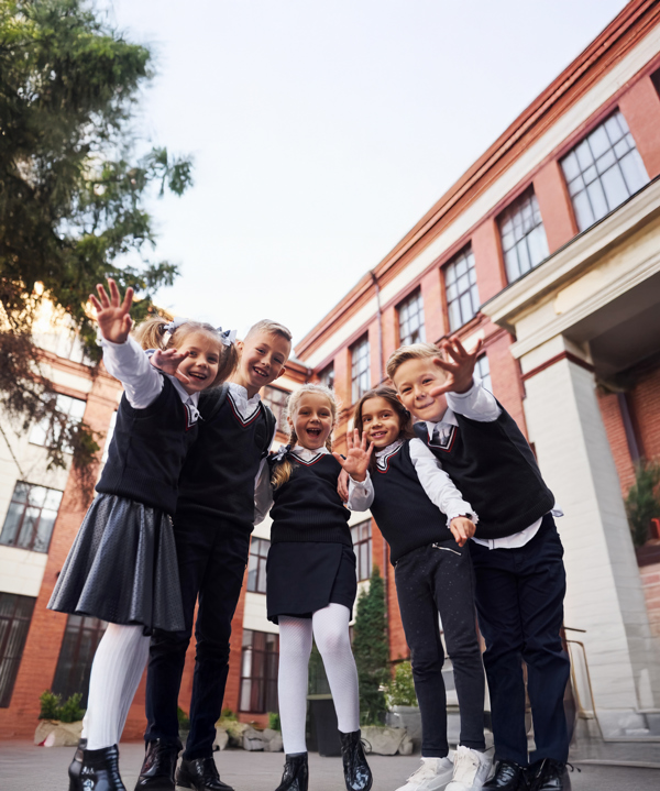 Having Fun Embracing Each Other Group Kids School Uniform That Is Outdoors Together Near Education Building